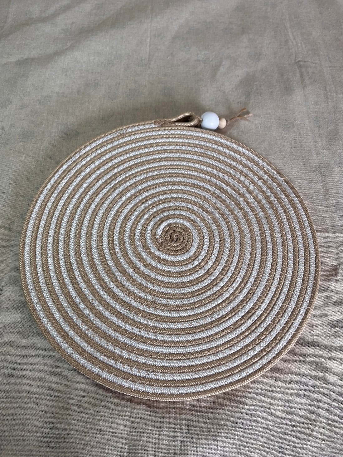 Top view of a coiled rope placemat spiralling to the centre